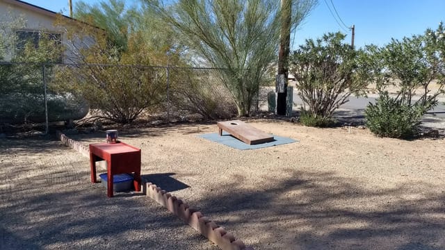 The bean bag toss court in a landscaped corner of the park