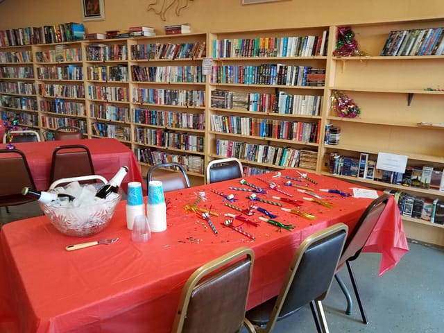 The clubhouse library, with shelves of books and tables set for a party